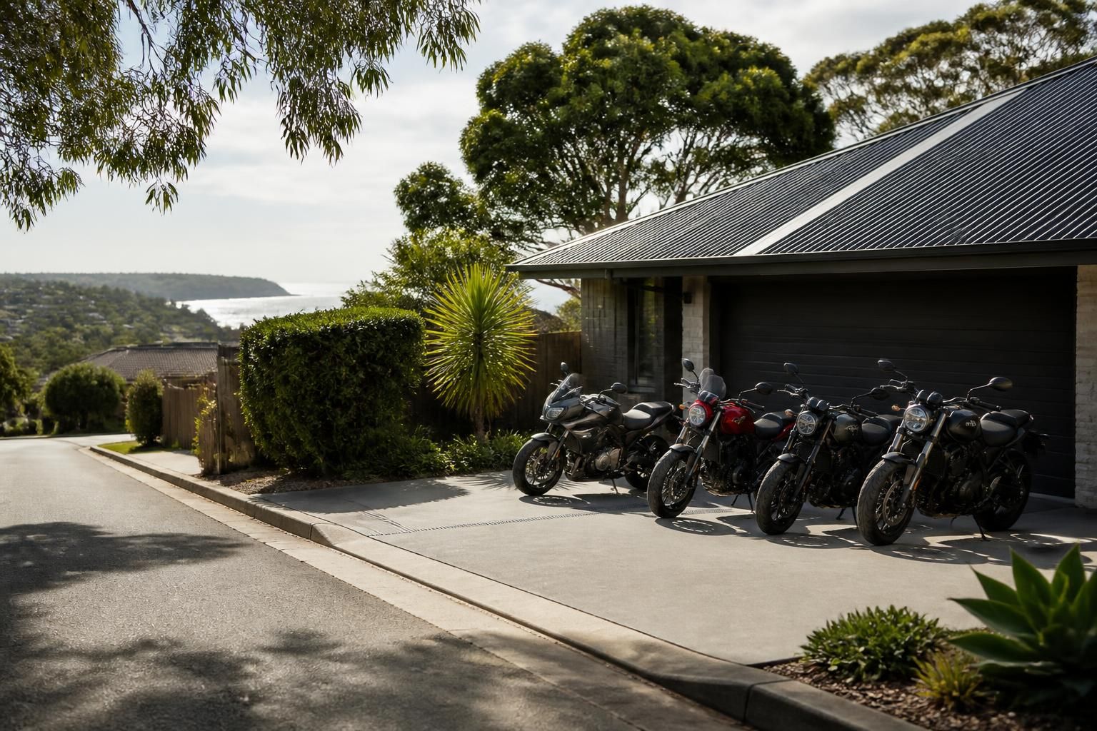 Central Coast street with a motorcycle collection point near a home.
