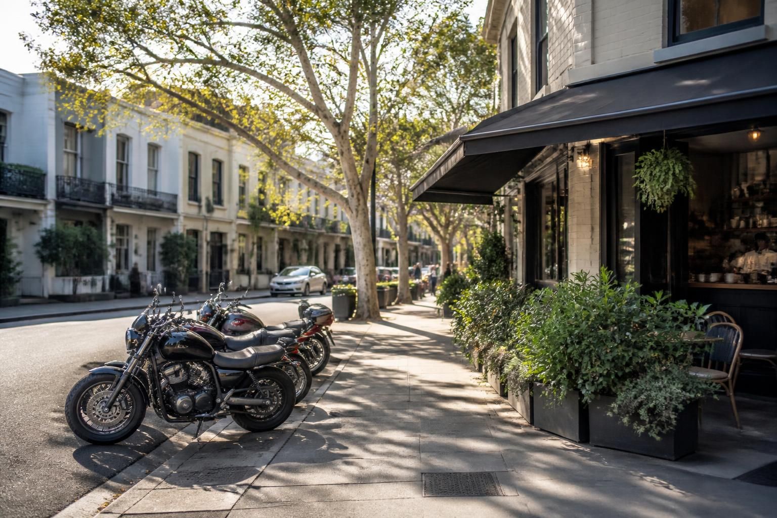 Sydney neighborhood street with parked motorcycles and tidy storefronts.