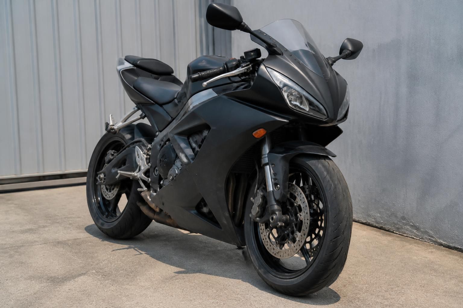 An unwanted motorcycle staged neatly for pickup.